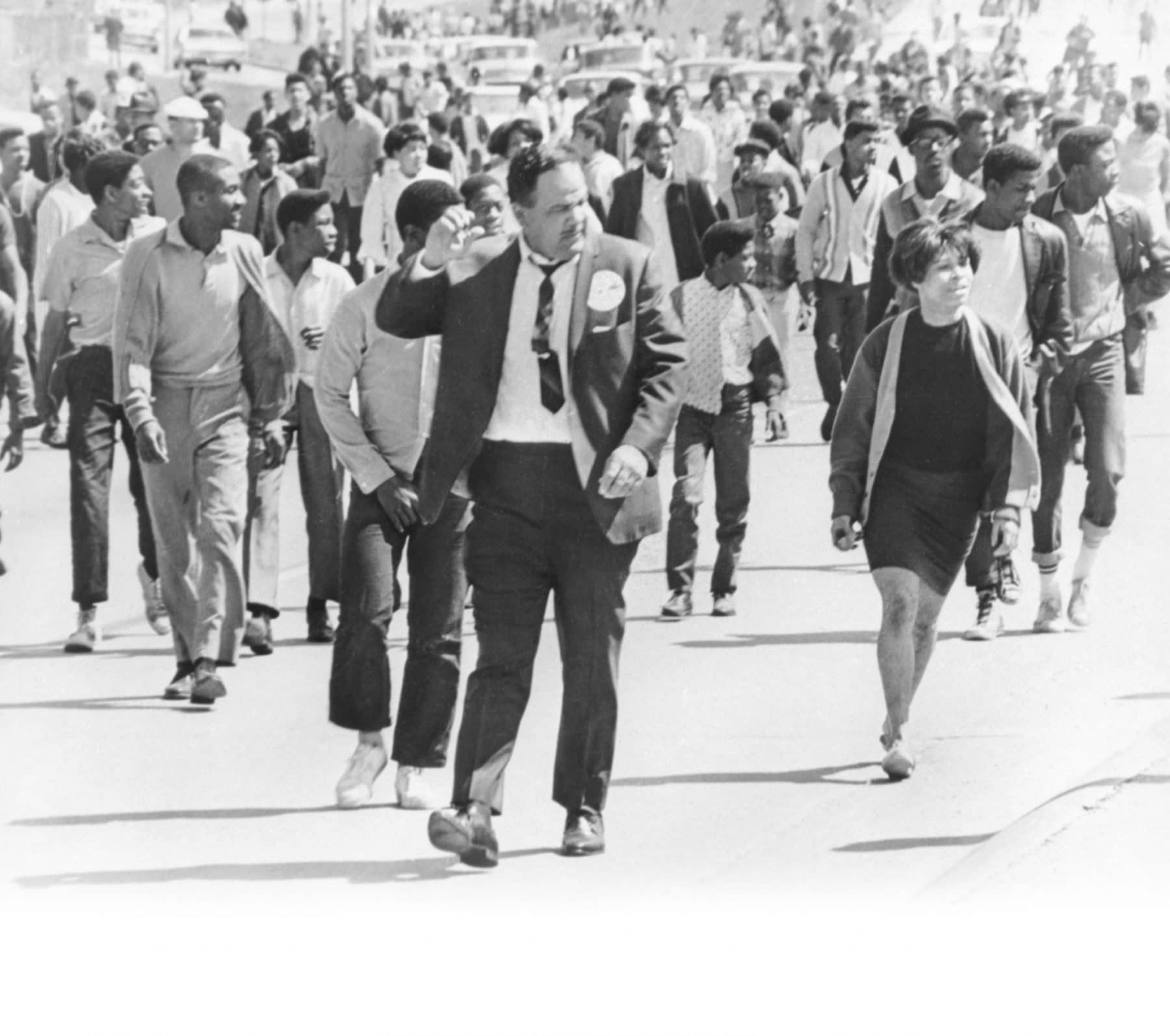 Bruce Watkins with crowd marching